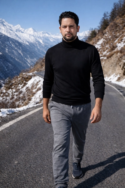 A man walking on a mountain road