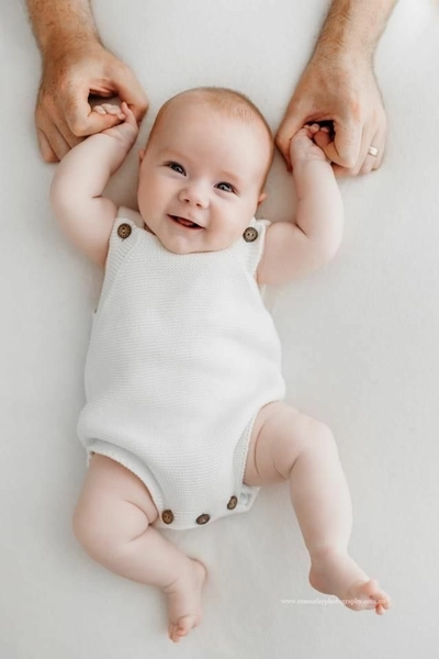 Newborn holding a hands of an adult.